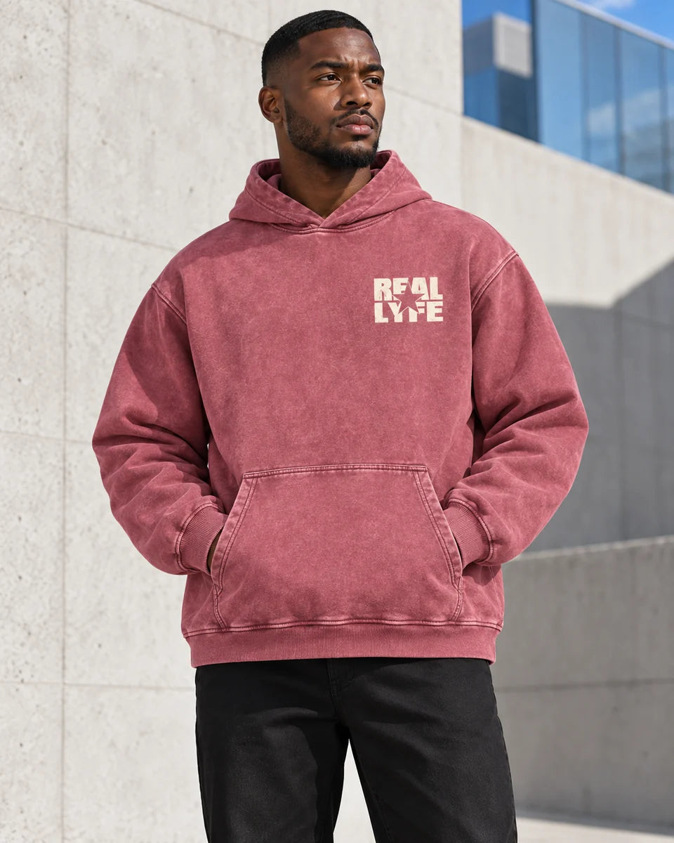 Explore all Reallyfe clothing: model wearing the washed-red Real Lyfe Center Logo Acid-Wash Hoodie